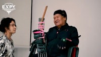 a man in a wheelchair talking to a woman
